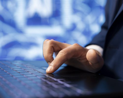 IT specialist coding on laptop, programming artificial intelligence computing simulating human brain. Programmer using technology gear to build AI machine learning algorithms, close up shot